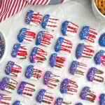 red white and blue pretzels on white parchment paper.
