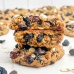 stack of oatmeal cherry cookies on white parchment paper.
