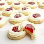 strawberry jam cookies on white parchment paper.