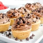 chocolate tartlets on a white platter.