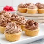 mini chocolate mousse tarts on white platter.