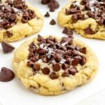 sugar cookies with chocolate chips on a white countertop.