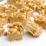 salted nut roll bar squares on a white surface.