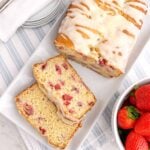 strawberry bread with lemon glaze on a white platter.