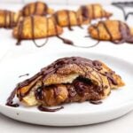 a cut-open chocolate hand pie on a white plate.