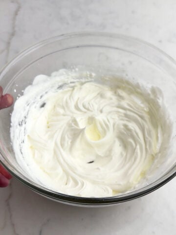whipped cream in a clear bowl.
