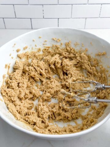 chocolate chip cookie dough in a white bowl.
