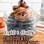 chocolate whipped cream on top of blueberries in a mason jar.