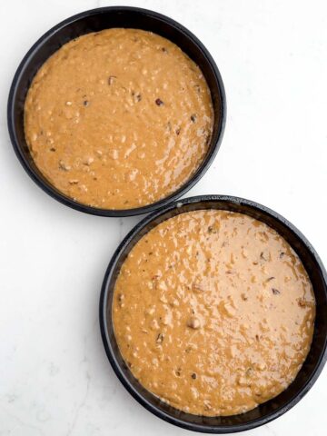 hummingbird cake batter in round cake pans.