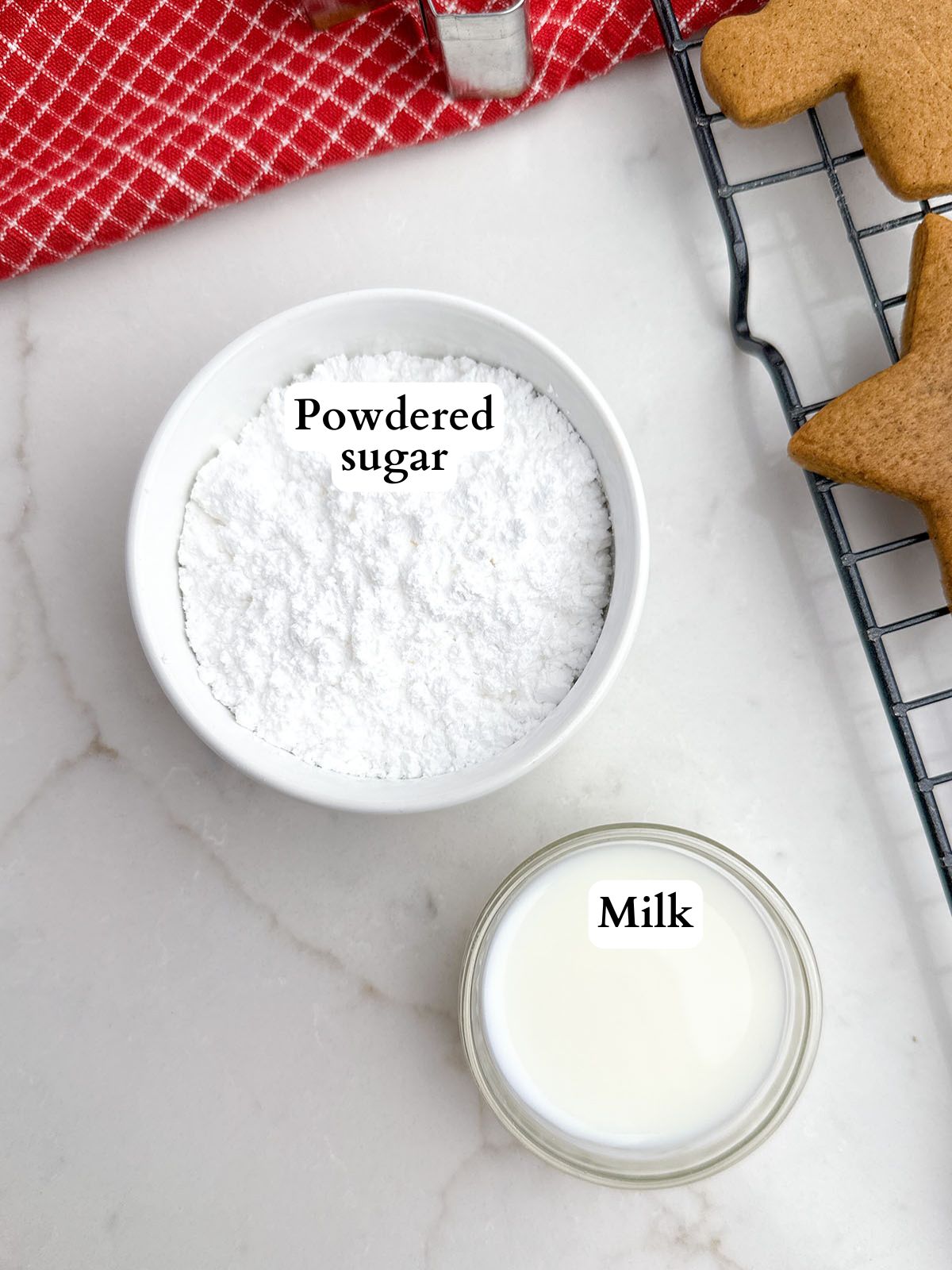 gingerbread icing ingredients on a white countertop.