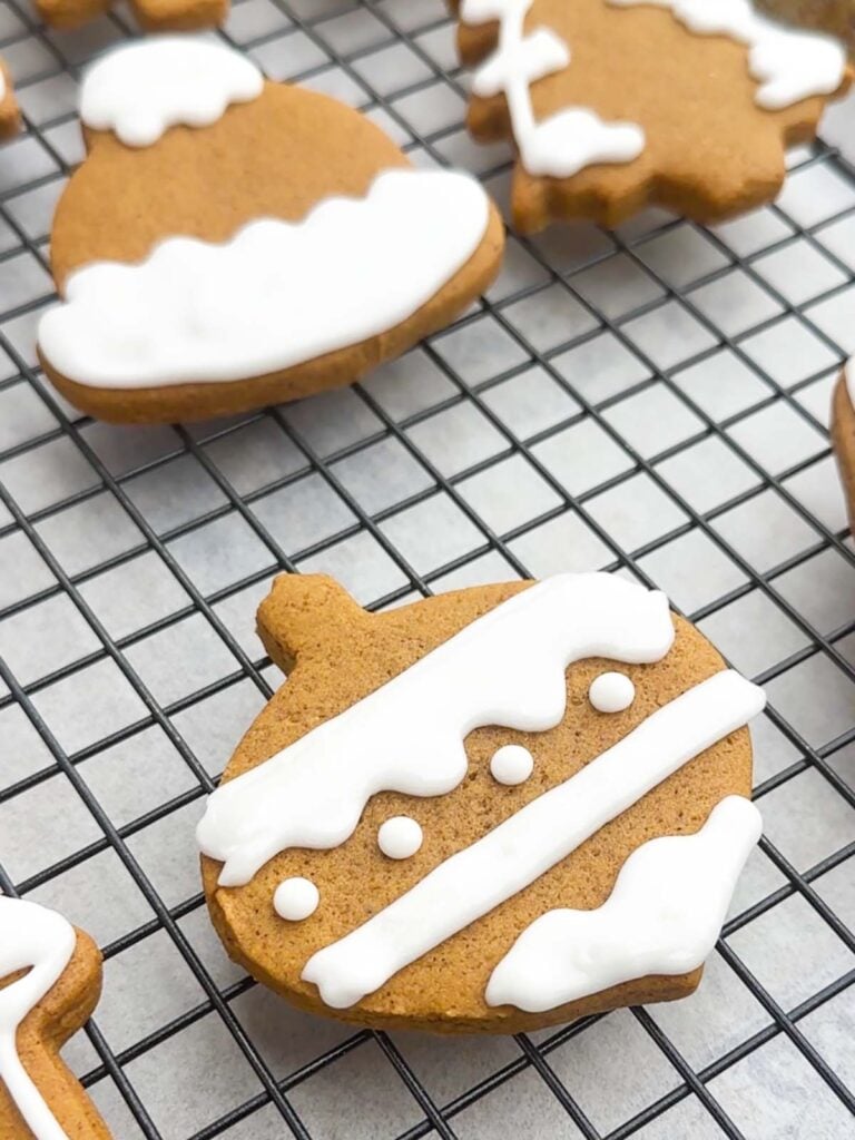 gingerbread cookie with icing on a wire rack.