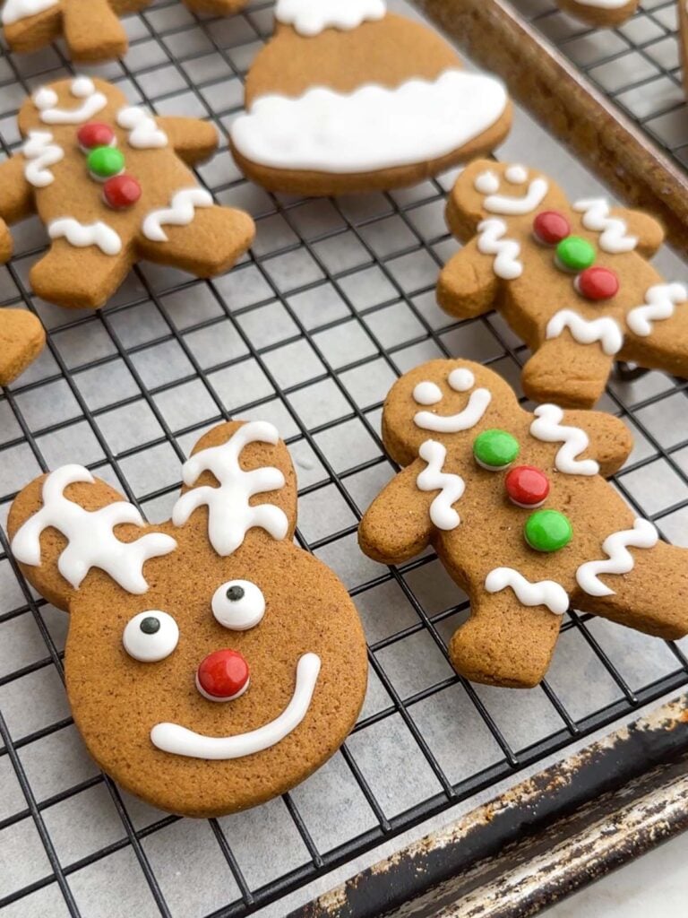 gingerbread cookies with icing on a wire rack.