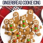 gingerbread man cookies with icing on a white plate.