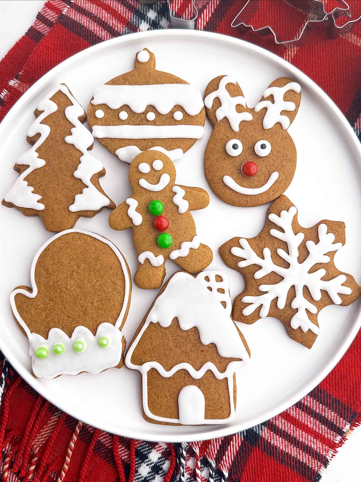 soft gingerbread cookies with icing on a white plate.