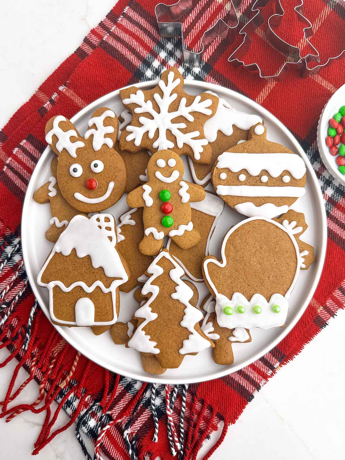 soft gingerbread cookies with icing on a white plate.