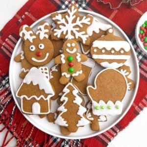 soft gingerbread cookies with icing on a white plate.