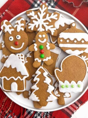 soft gingerbread cookies with icing on a white plate.