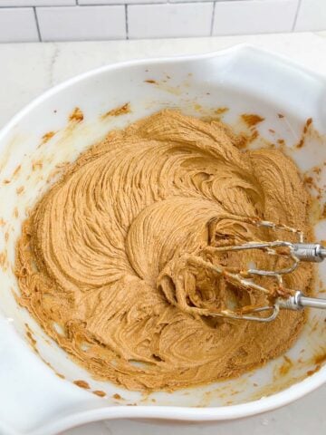 wet ingredients for gingerbread cookie batter in a white bowl.