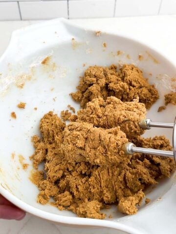 gingerbread cookie dough in a white mixing bowl.