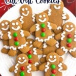 gingerbread men with white icing on a white plate.