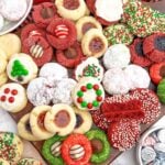 variety of cake mix christmas cookies on a wooden cutting board.