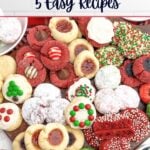 variety of cake mix christmas cookies on a wooden cutting board.