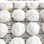 lemon snowball cookies rolled in powdered sugar on a baking rack.
