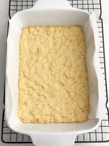 baked shortbread crust in a white baking pan. 