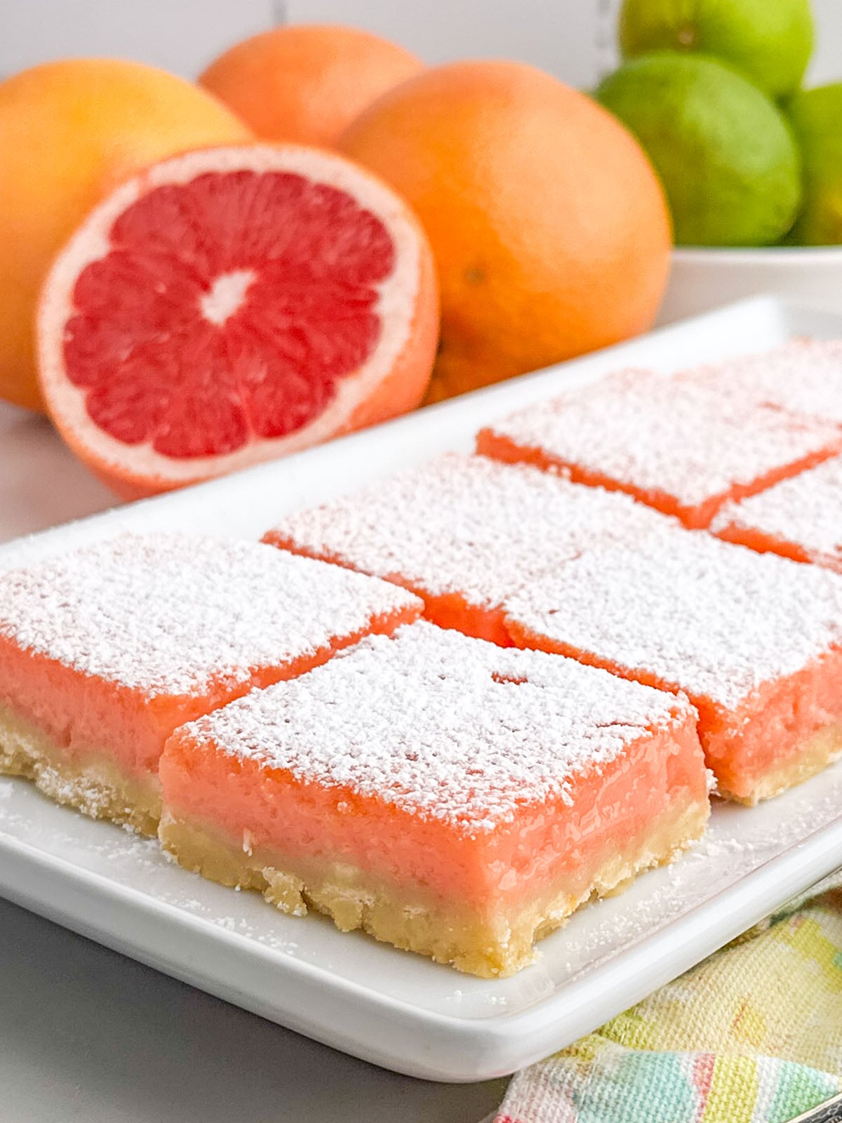 grapefruit bars on a white plate.