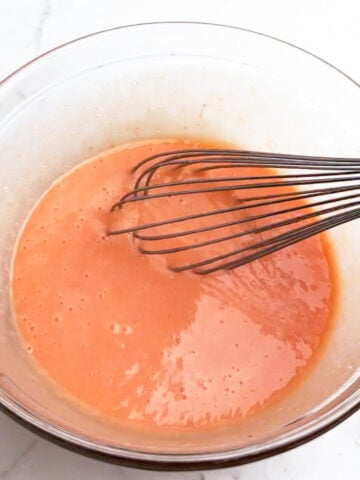grapefruit curd mixture in a clear bowl.