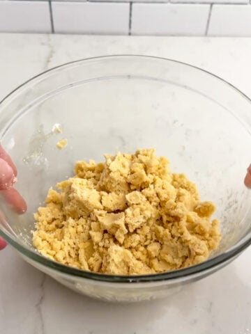 shortbread crust dough in a clear bowl.