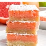 stack of grapefruit bars on a white plate.